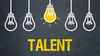 Fünf gezeichnete Glühbirnen hängen vom oberen Bildrand nach unten. Die mittlere Glühbirne leuchtet hell. Am unteren Bildrand steht das Wort "Talent".